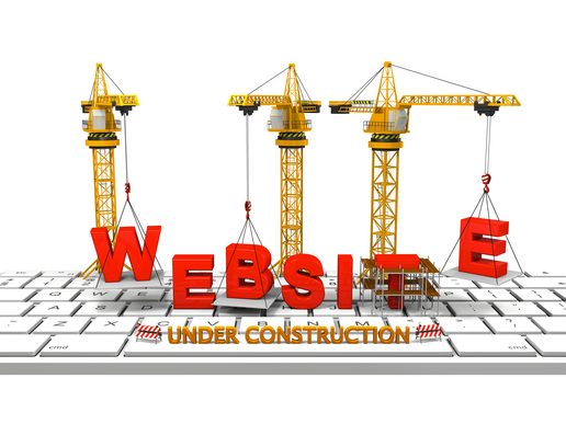 Cranes building a website on a computer keyboard, concept of website under construction